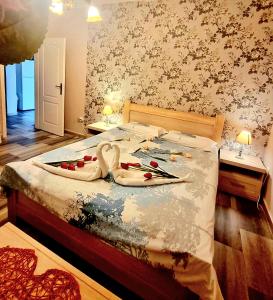 a bedroom with a bed with two swans on it at Apartments Krstos place in Kotor