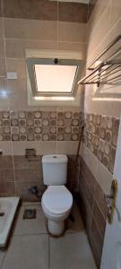a small bathroom with a toilet and a sink at شاليه فندقى للعائلات غرفة وريسيبشن بمنتجع ريتال فيو الساحل الشمالى in El Alamein