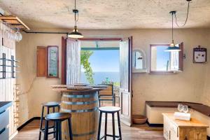 a kitchen with a bar and a view of the ocean at Casa Luciana, TerreMarine, Trekking and Nature in La Spezia