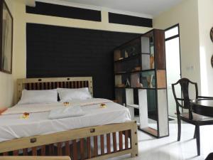 a bedroom with a large bed with a black wall at Jogoo rooms in Dar es Salaam