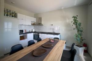 a kitchen with a wooden dining table and chairs at Zeusplace Pool Villa Olympus Riviera in Litochoro