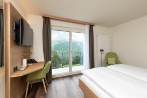 Rúm í herbergi á Berghotel Randolins