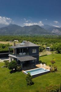 a house with a swimming pool in a yard at Zeusplace Pool Villa Olympus Riviera in Litochoro