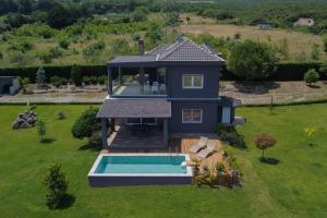 an aerial view of a house with a swimming pool at Zeusplace Pool Villa Olympus Riviera in Litochoro