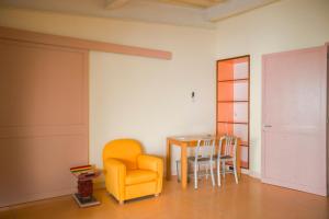 a dining room with a table and a yellow chair at ISLA SIMCA 