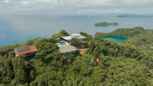 an aerial view of a house on a hill with water at ISLA SIMCA 
