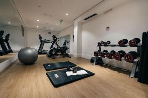 a gym with weights and exercise equipment in a room at Palmaroga Hotel in Asuncion