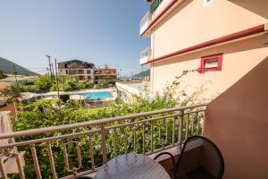 a balcony of a condo with a view of a pool at Kalias Hotel in Vasiliki