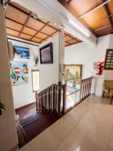 a staircase in a house with paintings on the walls at ApartHotel Maison Suisse in Asuncion