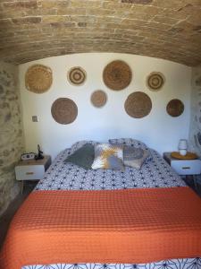 a bedroom with a bed with baskets on the wall at So Home in Saint-Pantaléon-les-Vignes