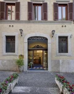 an entrance to a building with two benches in front at Hotel Residenza In Farnese in Rome