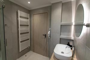 a bathroom with a white sink and a mirror at Mary‘s Apartments in Mesopótamon +51 photos