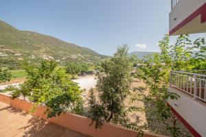 a view from the balcony of a house with trees at Kalias Hotel in Vasiliki