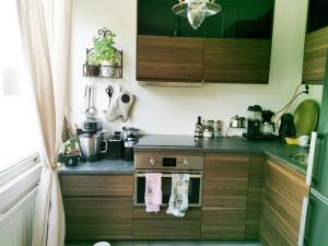 a kitchen with a sink and a stove with towels at Comfy boho-studio in Kallio. in Helsinki