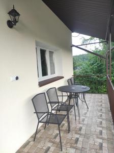 a patio with a table and chairs on a balcony at Agroturystyka Huta in Krzywe