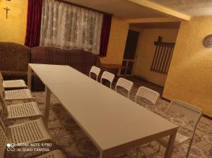 a room with a table and chairs and a couch at Agroturystyka Huta in Krzywe