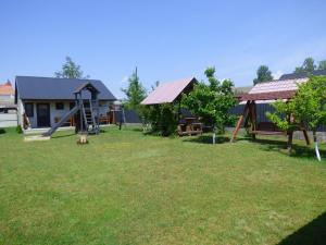 a yard with a playground and a house at Приватна Садиба "У Оксани" in Pulʼmo