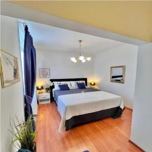 a bedroom with a large bed with blue pillows at Seaside Lux in Dugi Rat