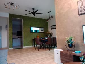 a living room with a table and a ceiling fan at Muslim Homestay at Meru Ipoh With Swimming Pool & Free Parkings in Ipoh