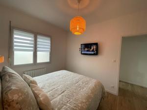 a bedroom with a bed and a tv on the wall at Banting Room in Dury