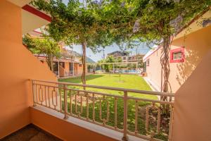a balcony with a view of a yard at Kalias Hotel in Vasiliki