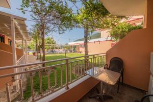 a balcony with a chair and a view of a park at Kalias Hotel in Vasiliki