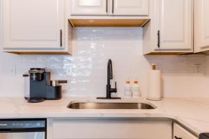 a kitchen counter with a sink and a coffee maker at Coastal Luxe Villa by the Beach in Hilton Head Island