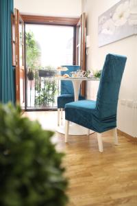 a dining room with blue chairs and a table at Villanova Sweet Home in Cagliari