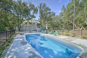a swimming pool in front of a house at Kitty Hawk Vacation Rental with Pool and Hot Tub in Kitty Hawk