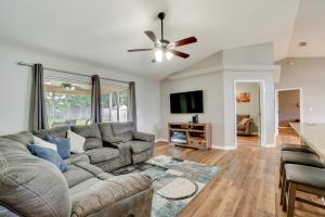a living room with a couch and a ceiling fan at Minneola Home with Screened Porch, 25 Mi to Disney! in Minneola