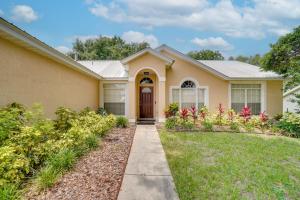 a house with a pathway leading to the front door at Minneola Home with Screened Porch, 25 Mi to Disney! in Minneola