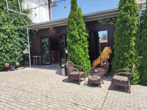 a group of chairs and tables in front of a building at В Гостях на Иссык-Куле in Cholpon-Ata