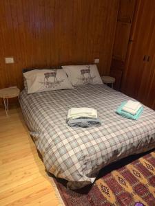a bedroom with a bed with two towels on it at Miri Apartment in Alagna Valsesia