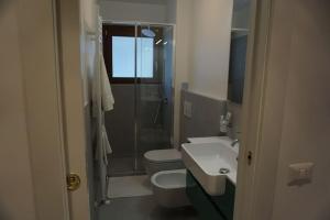 a bathroom with a toilet and a sink and a shower at Miri Apartment in Alagna Valsesia +13 photos