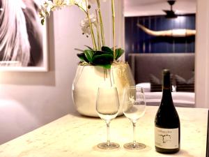Una botella de vino y dos copas en una mesa en The Burbank House, en Fredericksburg
