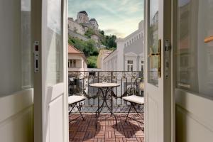 a view from the door of a balcony with a table at Apartmán s balkónom in Trenčín