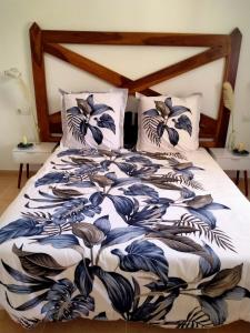 a bed with a blue and white blanket and pillows at Apto Puipana in Corralejo