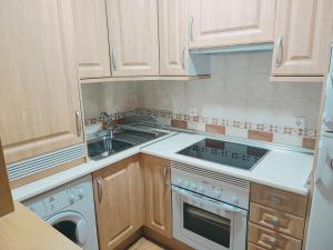 a kitchen with a sink and a stove top oven at Apartamento Los Vencejos in Ruidera +33 photos