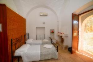 a bedroom with two beds and a staircase at La Piana degli Ulivi in Ostuni +26 photos