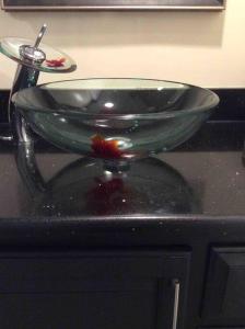 a glass sink sitting on top of a counter at Spacious Light & Bright Private Apartment in Great Falls