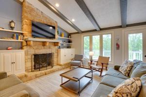 a living room with a couch and a fireplace at Lakefront Cadiz Home with Hot Tub! in Cadiz