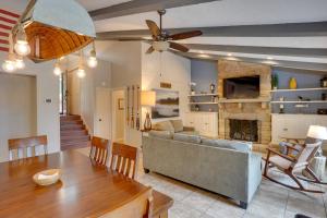 a living room with a couch and a fireplace at Lakefront Cadiz Home with Hot Tub! in Cadiz