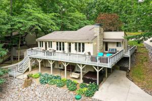 an aerial view of a house with a deck at Lakefront Cadiz Home with Hot Tub! in Cadiz