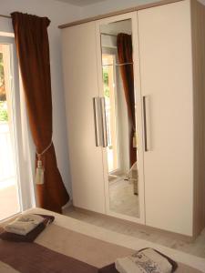a bedroom with a mirrored cabinet and a mirror at Apartment Marbella in Dubrovnik