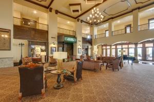 a large lobby with chairs and a grand piano at Resort Apartment in Loretto with Private Patio! in Loretto