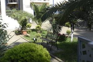 a park bench sitting in the grass with plants at National+ in Ureki