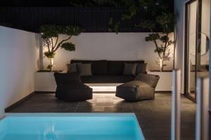 a living room with a couch and a pool at Hygge Suites in Hersonissos