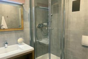 a bathroom with a shower and a sink at Spreehotel Spremberg in Spremberg