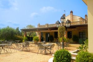 a patio with tables and chairs in front of a building at Agriturismo Casacchella in San Nico