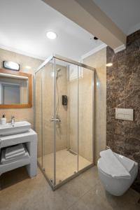 a bathroom with a shower and a toilet and a sink at Costa Viva Bodrum in Bodrum City